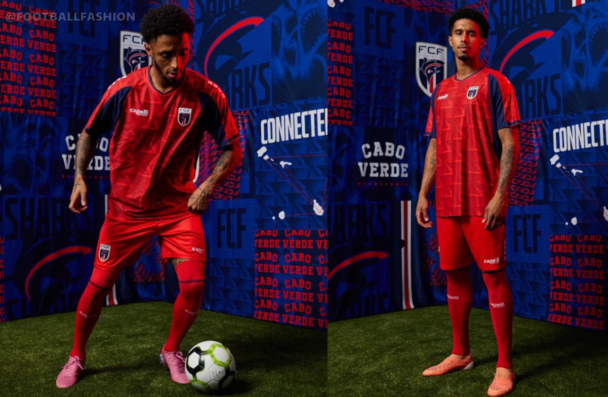 Player wearing the red Cabo Verde 2026 third jersey with a geometric pattern, dark blue sleeve panels, and federation crest.