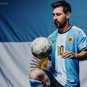 Front view of the sky-blue and white Argentina 2026 jersey featuring gold Messi logo and gold number 10.