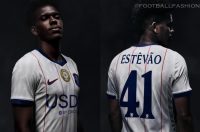 Chelsea FC player modeling the white 2026/27 Nike third jersey with red pinstripes, blue trim, and a retro club crest.