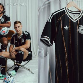 The black Germany 2026 Jersey featuring vertical gold diamond lines, white Trefoil logo, and four-star DFB badge.