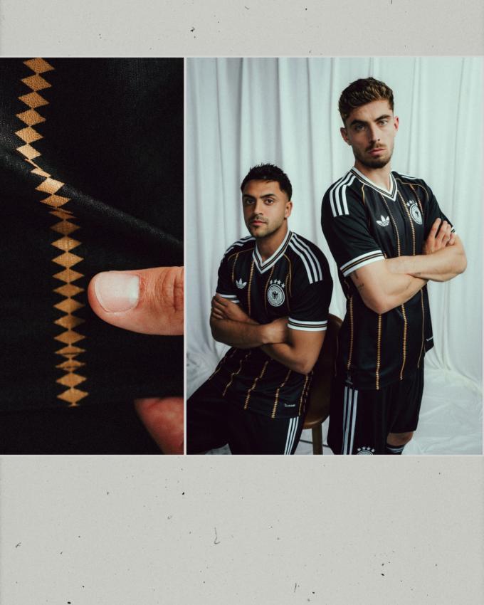 The black Germany 2026 Jersey featuring vertical gold diamond lines, white Trefoil logo, and four-star DFB badge.